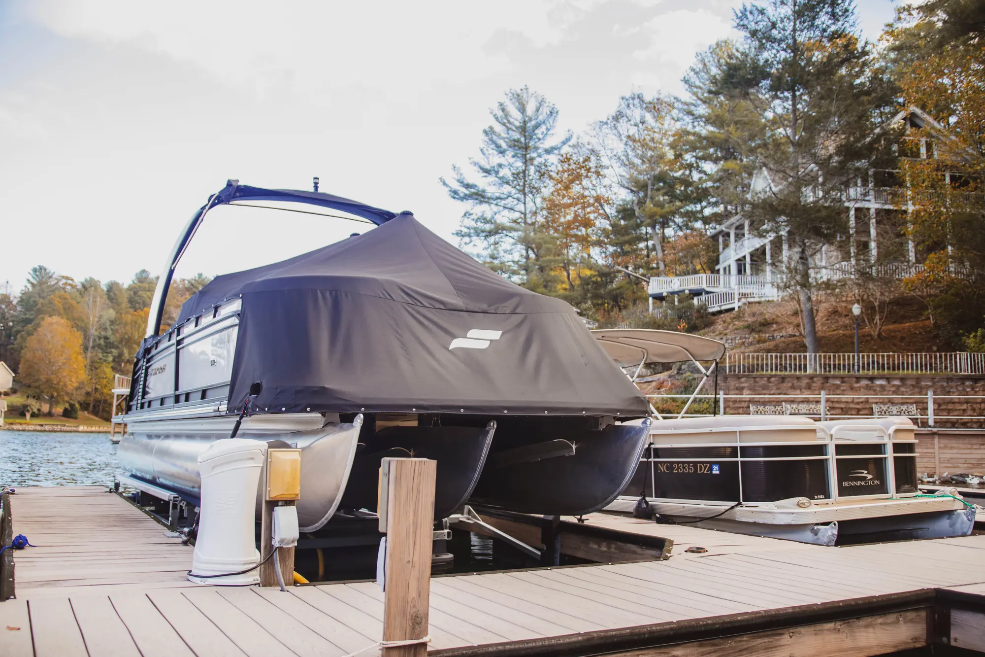 Covered boat docked at a lakeside pier