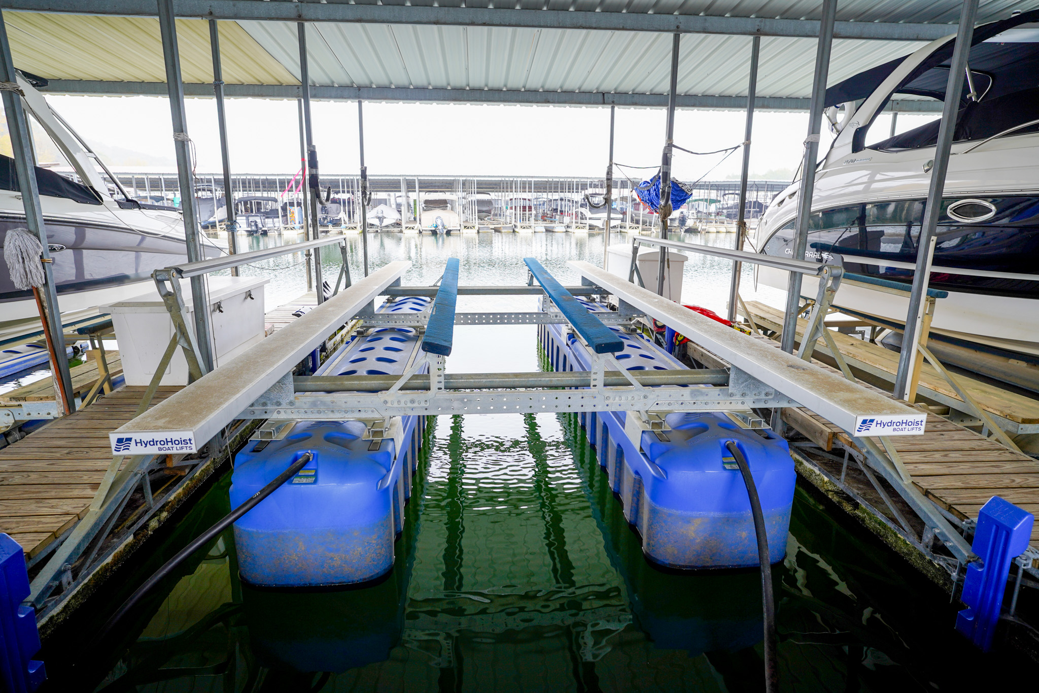 A HydroHoist boat lift in a covered marina slip. 